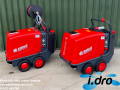Two Red Ehrle HD Hot Water Mobile Pressure Washers. The one on the left is a premium model with hose reel and the one on the right is a standard model.